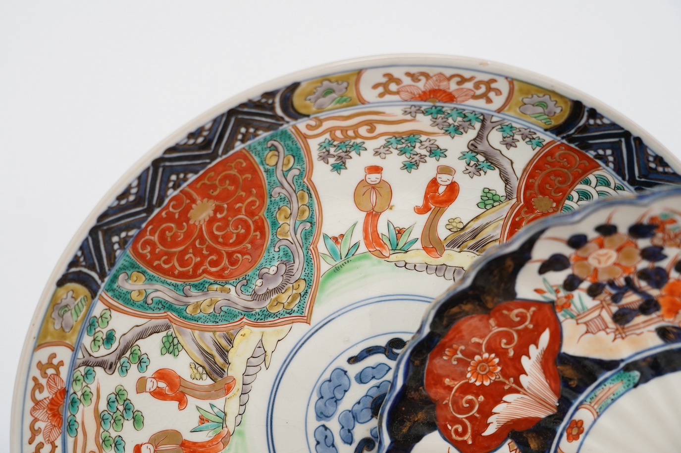 Five Japanese Imari dishes and a Kutani gilt metal mounted bowl, Meiji period, largest 35cm. Condition - poor to fair